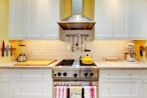 Narrow-white-and-yellow-kitchen-with-cabinets-close-up-300x200